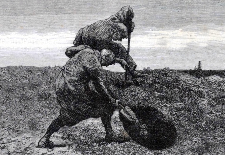 Two men digging a hole.